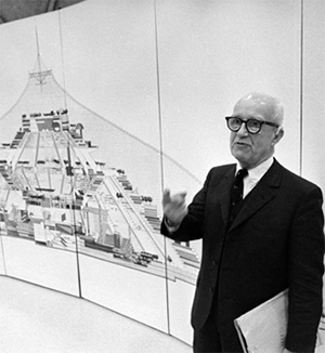 Image of Buckminster Fuller standing next to a diagram.